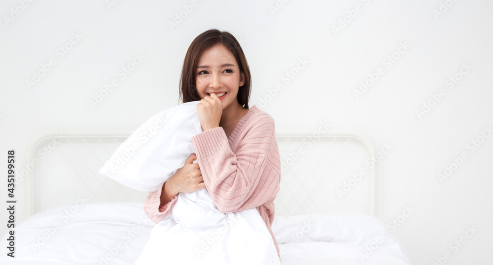 Smiling of cheerful beautiful pretty asian woman clean fresh healthy white skin posing in warm knitted pink clothes.Girl felling relaxing and enjoy time on the bed at home.asia beauty Smiling of cheerful beautiful pretty asian woman clean fresh healthy white skin posing in warm knitted pink clothes.Girl felling relaxing and enjoy time on the bed at home.asia beauty
