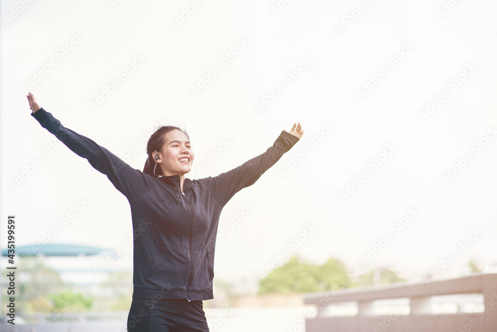 Young Asain woman with sportwear looking relaxing at outdoor. People relax and freedom style. Success of life concept. Young Asain woman with sportwear looking relaxing at outdoor. People relax and freedom style. Success of life concept.