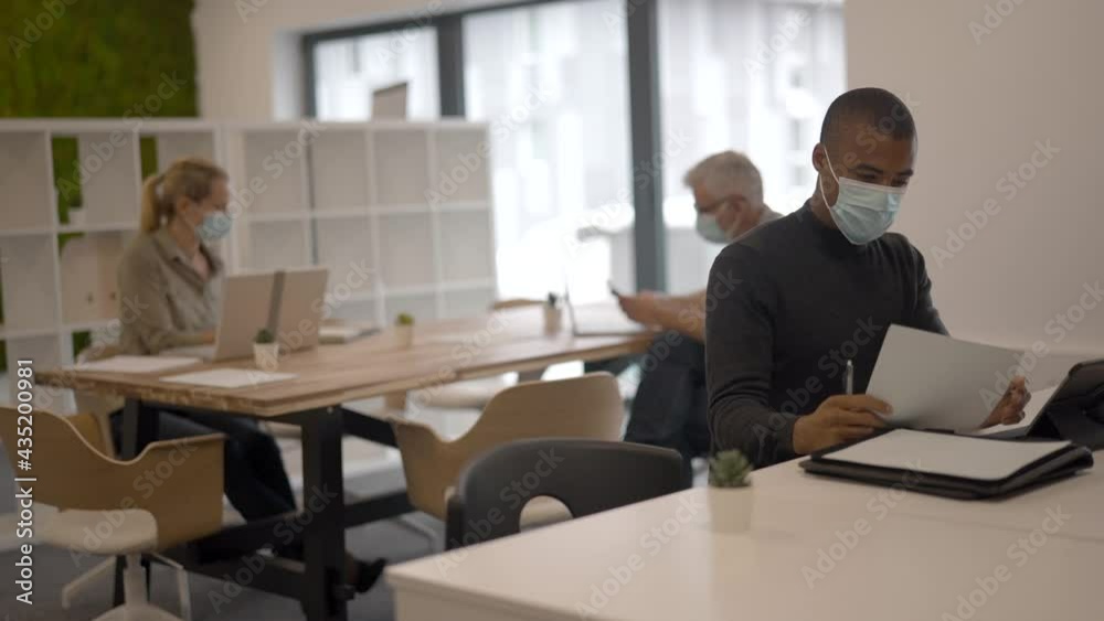 Business people in co-working office during pandemic Business people in co-working office during pandemic