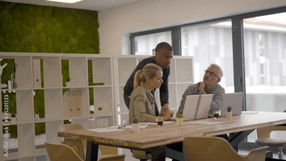 Business people in modern meeting room working together on project Business people in modern meeting room working together on project