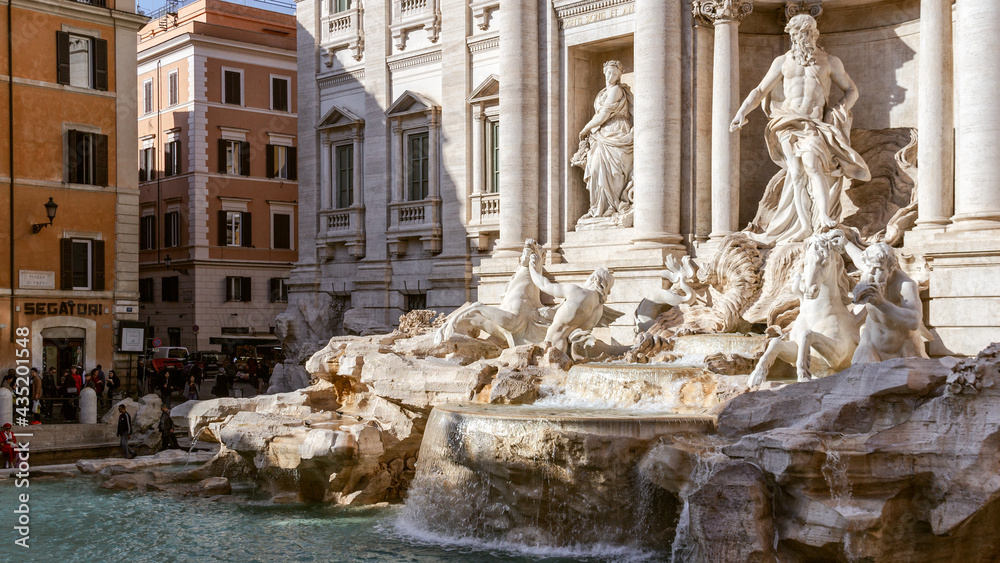 The famous Trevi fountain in Rome with graceful sculptures