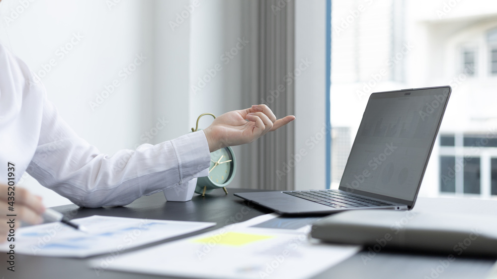 Asian business women are analyzing graphs, financial statistics and calculating corporate returns in private offices, Market research reports and income statistics, Financial and Accounting concept. Asian business women are analyzing graphs, financial statistics and calculating corporate returns in private offices, Market research reports and income statistics, Financial and Accounting concept.