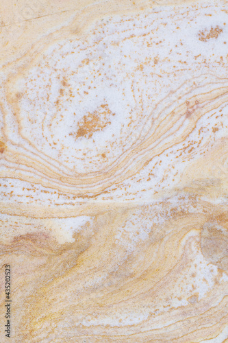 Natural stone background texture with orange, beige and gray tones