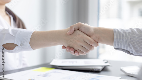 Business personage handshake, Asian business women congratulate on being a corporate partnership with European male investors, Friendship building, Sign language greetings, Business negotiation.