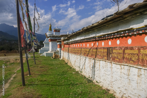 Beautiful prayer wall with chorten and buddhist banners in late afternoon light  Paro valley  Bhutan