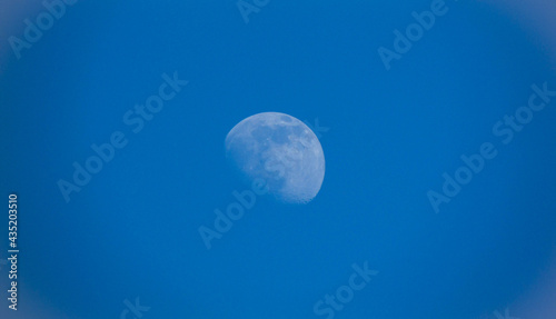 moon centered close-up against blue sky
