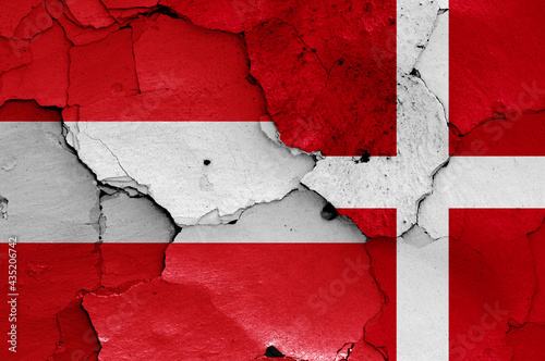 flags of Austria and Denmark painted on cracked wall