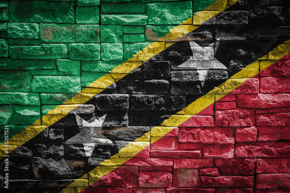 National flag of Saint Kitts and Nevis on stone  wall background.The concept of national pride and symbol of the country. Flag  banner on  stone texture background.