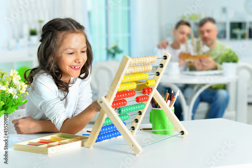 Cute little girl learning to use abacus