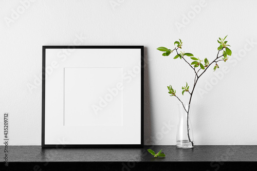 Frame mockup. Poster with plant in vase. Black square photo frame with passepartout.
