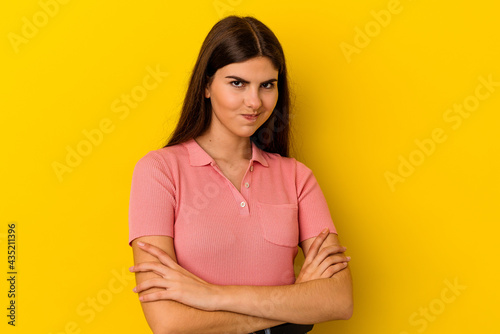 Young caucasian woman isolated on yellow background who is bored, fatigued and need a relax day.