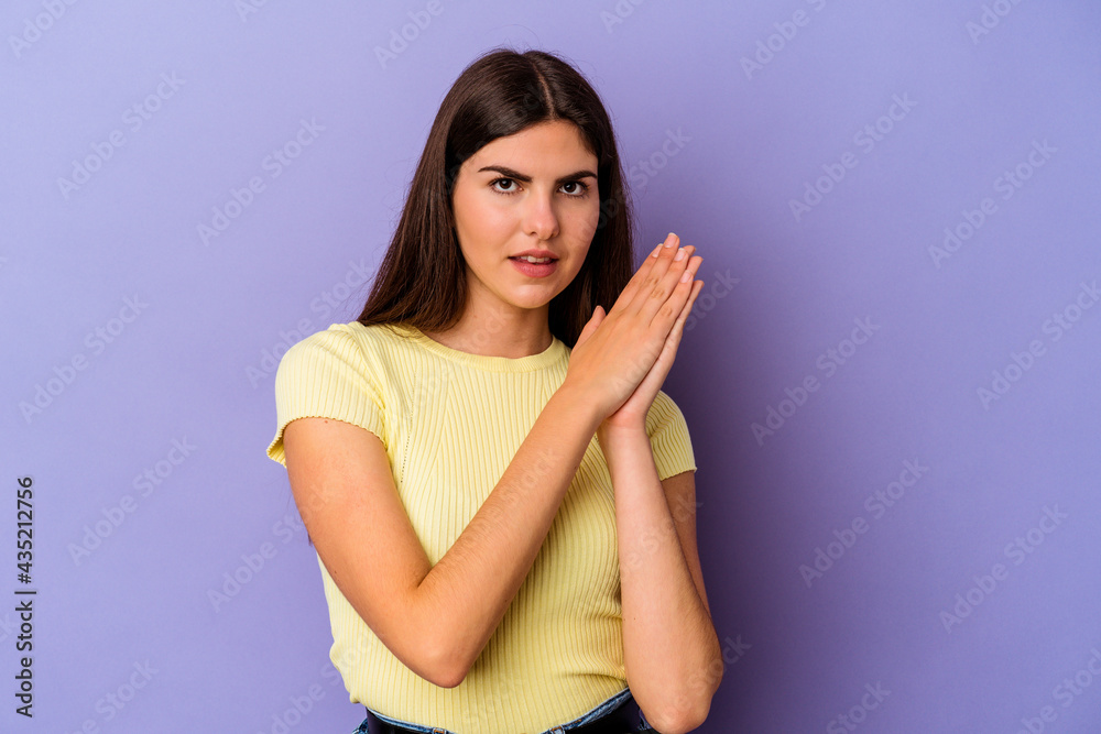 Young caucasian woman isolated on purple background feeling energetic and comfortable, rubbing hands confident. Young caucasian woman isolated on purple background feeling energetic and comfortable, rubbing hands confident.