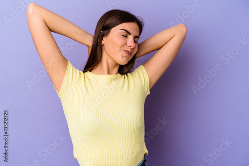 Young caucasian woman isolated on purple background suffering neck pain due to sedentary lifestyle.