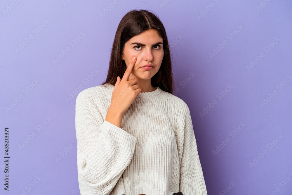 Young caucasian woman isolated on purple background crying, unhappy with something, agony and confusion concept. Young caucasian woman isolated on purple background crying, unhappy with something, agony and confusion concept.