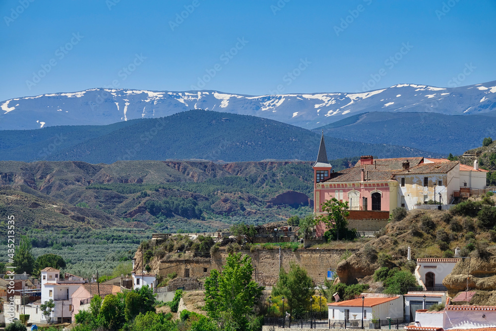View of the Palace of the Gallardo in Marchal (Granada - Spain) with Sierra Nevada in the background. It is a pink stately house known as 