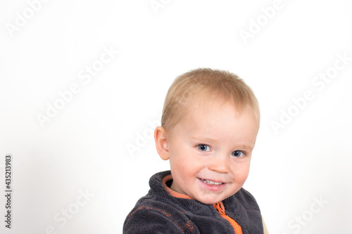 Portrait of little caucasian boy. Smiling baby face with white teeth isolated on white background.