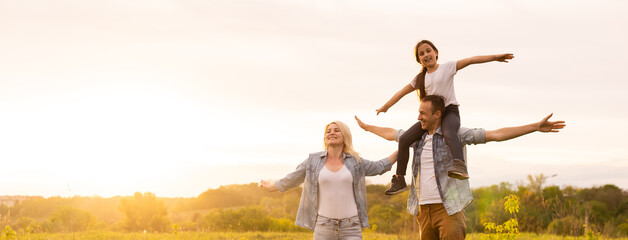 Young happy family in a field