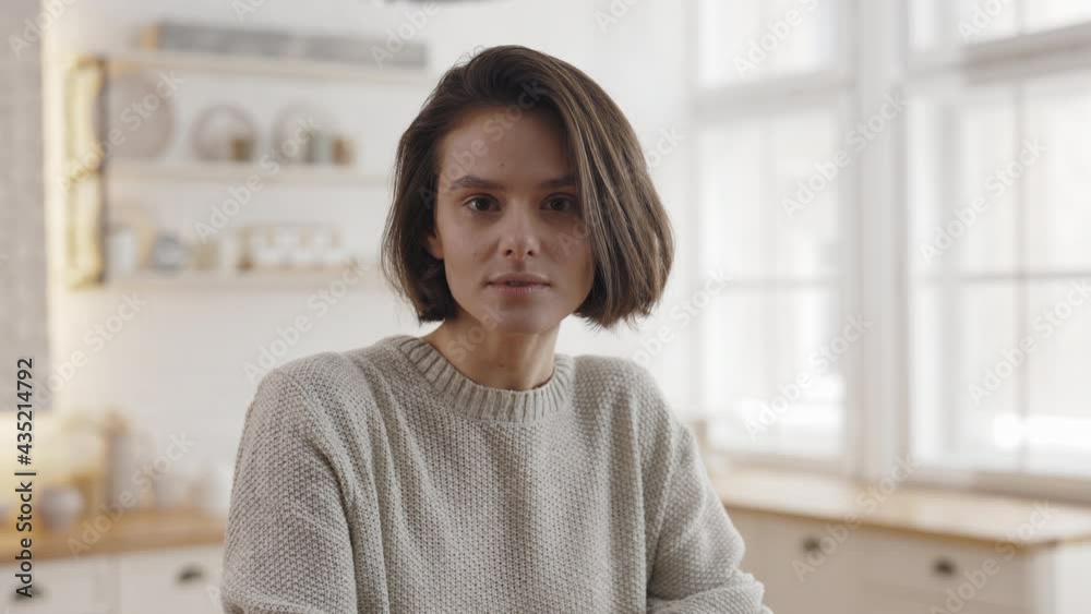Portrait of caucasian woman posing on bright kitchen Portrait of caucasian woman posing on bright kitchen