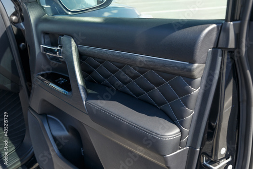 Wallpaper Mural Luxury leather interior trim with white diamond stitching. Car interior. Car door interior trim and door handle. Luxurious car instrument cluster. Close up shot of automobile instrument panel Torontodigital.ca