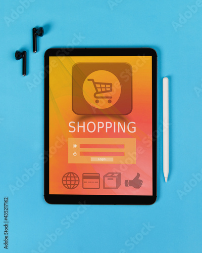 Digital tablet with online shop on screen on blue background