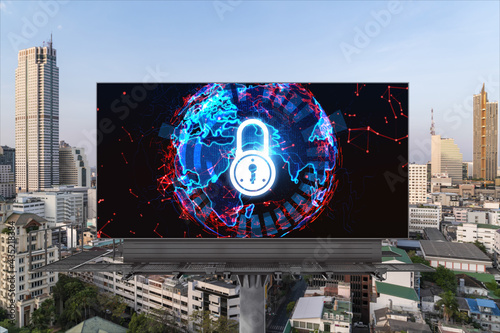 Padlock icon hologram on road billboard over panorama city view of Bangkok at day time to protect business, Southeast Asia. The concept of information security shields.