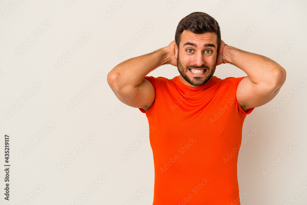 Young caucasian man isolated on white background touching back of head, thinking and making a choice. Young caucasian man isolated on white background touching back of head, thinking and making a choice.