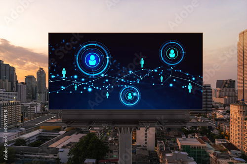 Glowing Social media icons on billboard over sunset panoramic city view of Bangkok. The concept of networking and establishing new connections between people and businesses in Southeast Asia photo