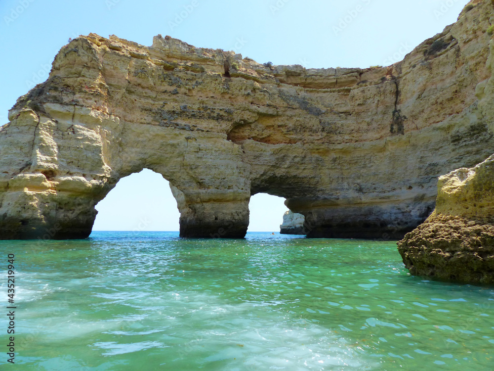 Rock formation with arches at Praia da Marinha, the Algarve, Portugal. 