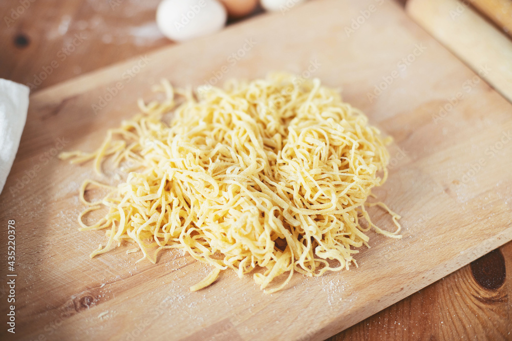 The process of cooking homemade noodles, spaghetti, pasta.