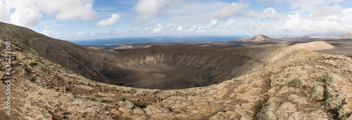 Volcano Panorama with a blue sky, extinct volcanic crater on Lanzarote, Spain. Beautiful Lanscpae Backgriund. photo