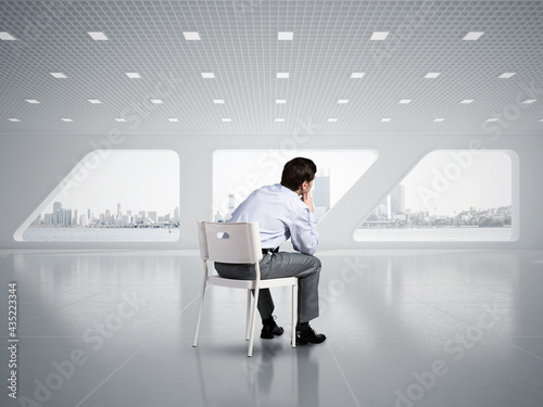 Young businessman sitting on an office chair © adam121