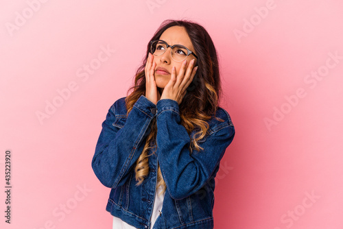Young mexican woman isolated on pink background whining and crying disconsolately.