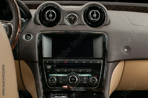 Luxury car interior. Multimedia screen and control buttons.