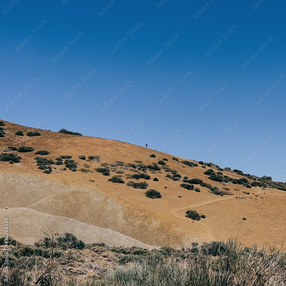 landscape in the desert, a man climbing