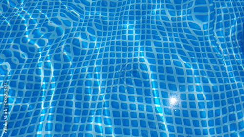 Water surface texture with looping clean swimming pool ripples and waves.