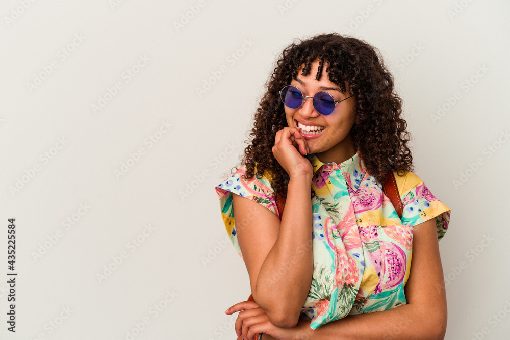 Young mixed race woman wearing sunglasses taking a vacation isolated relaxed thinking about something looking at a copy space. Young mixed race woman wearing sunglasses taking a vacation isolated relaxed thinking about something looking at a copy space.