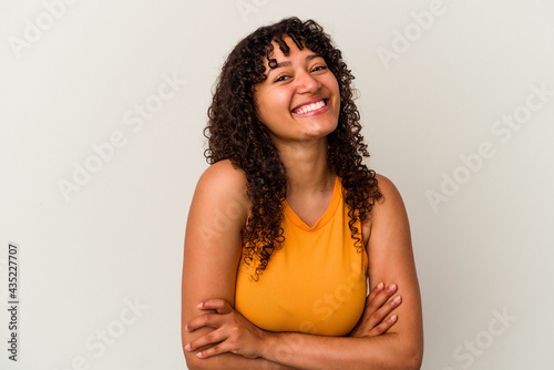 Young mixed race woman isolated on white background laughing and having fun.