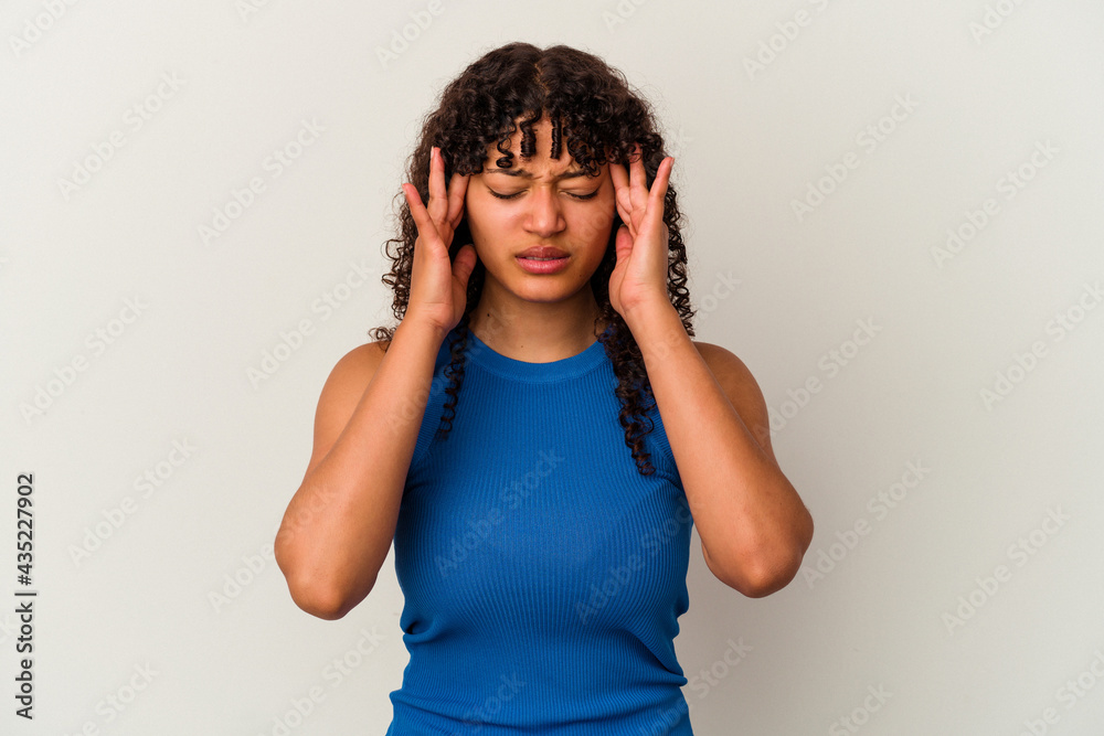 Young mixed race woman isolated on white background touching temples and having headache. Young mixed race woman isolated on white background touching temples and having headache.