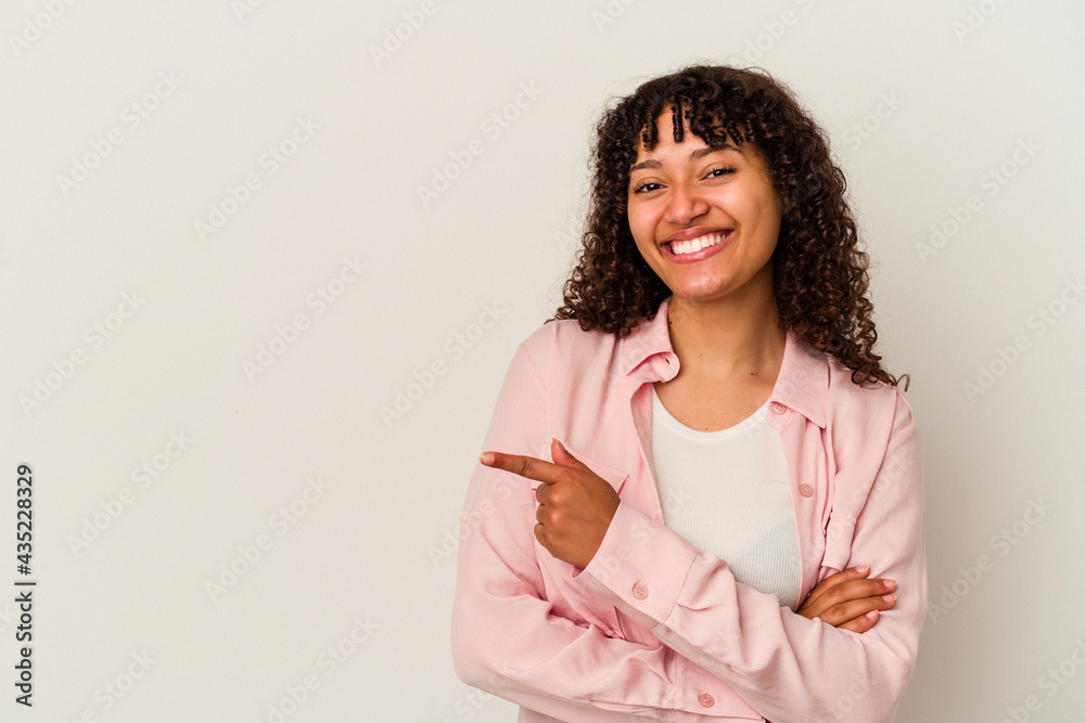 Young mixed race woman isolated on white background smiling cheerfully pointing with forefinger away. Young mixed race woman isolated on white background smiling cheerfully pointing with forefinger away.