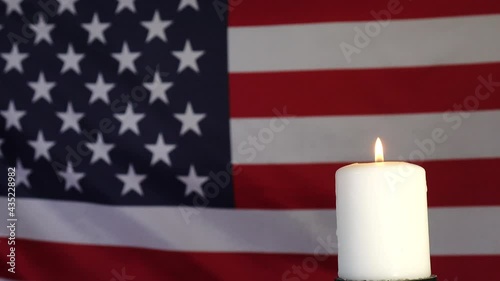 A candle on the background of the American flag. A day of remembrance, celebration, and mourning. Independence Day, an American holiday. Flag of the United States. photo