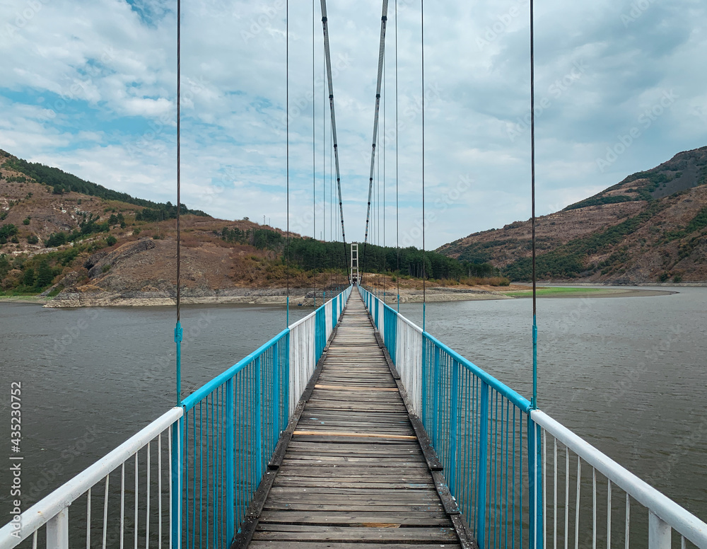 Pedestrian cable suspension bridge over waters leading to Lisitsite village in Bulgaria