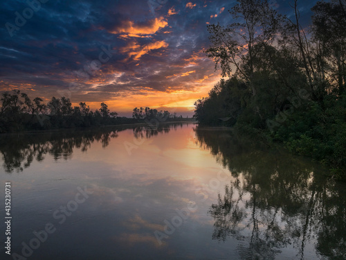 venice canal with fog and reflection at sunrise in summer