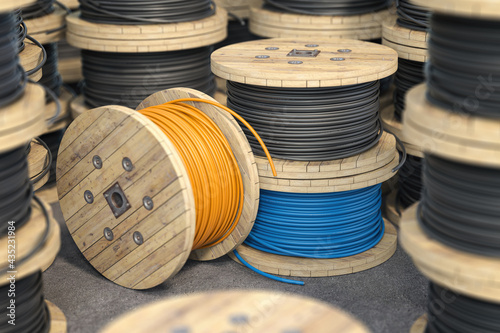 Wire electric cable on wooden coil or spool isolated on warehouse. photo