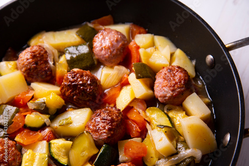 Meatballs with roasted vegetables. Traditional Spanish tapa.