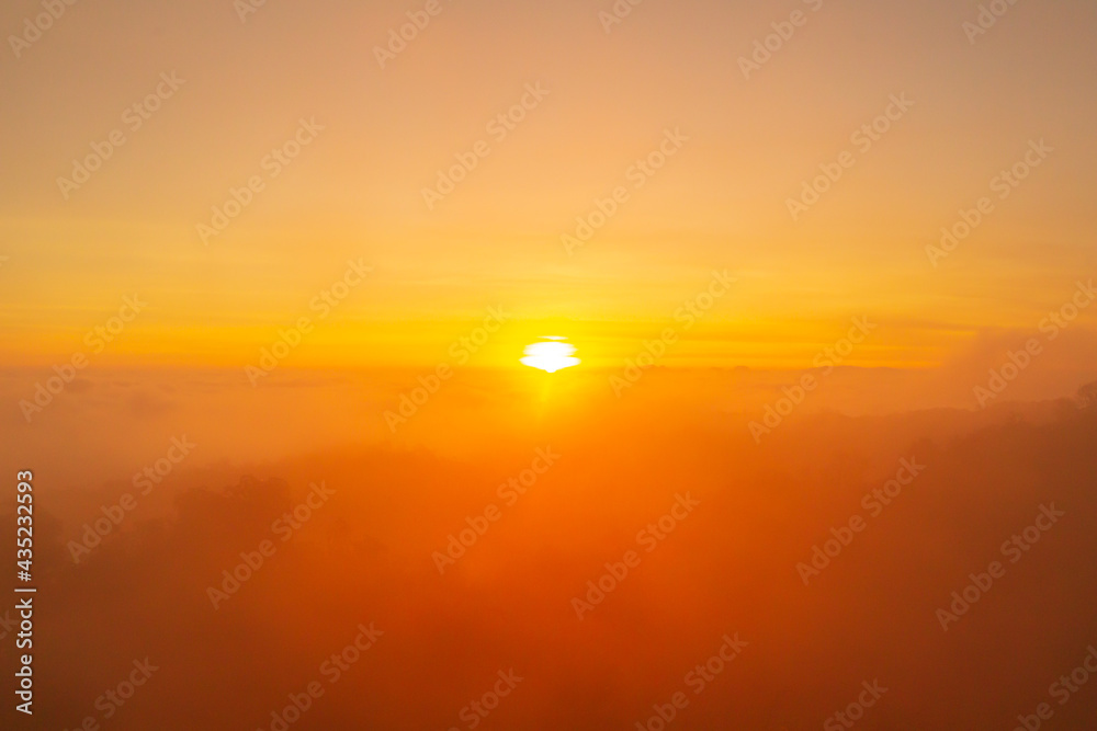 First light of the day at sunrise time in the morning over clouds fog or mist on the mountain forest. First light of the day at sunrise time in the morning over clouds fog or mist on the mountain forest.