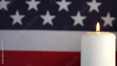 A candle on the background of the American flag. A day of remembrance, celebration, and mourning. Independence Day, an American holiday. Flag of the United States. photo