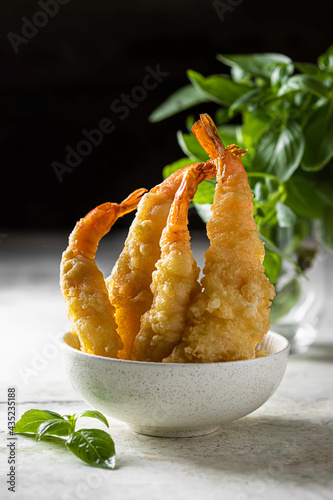 Delicious shrimp tempura on light gray concrete background. Breaded prawns.