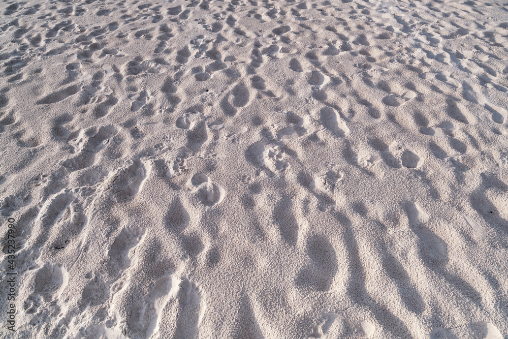 Detail texture of white sand Sea sun beach for relax in holiday Sunny summer background with foot print on sand beautiful beach in phuket thailand Detail texture of white sand Sea sun beach for relax in holiday Sunny summer background with foot print on sand beautiful beach in phuket thailand