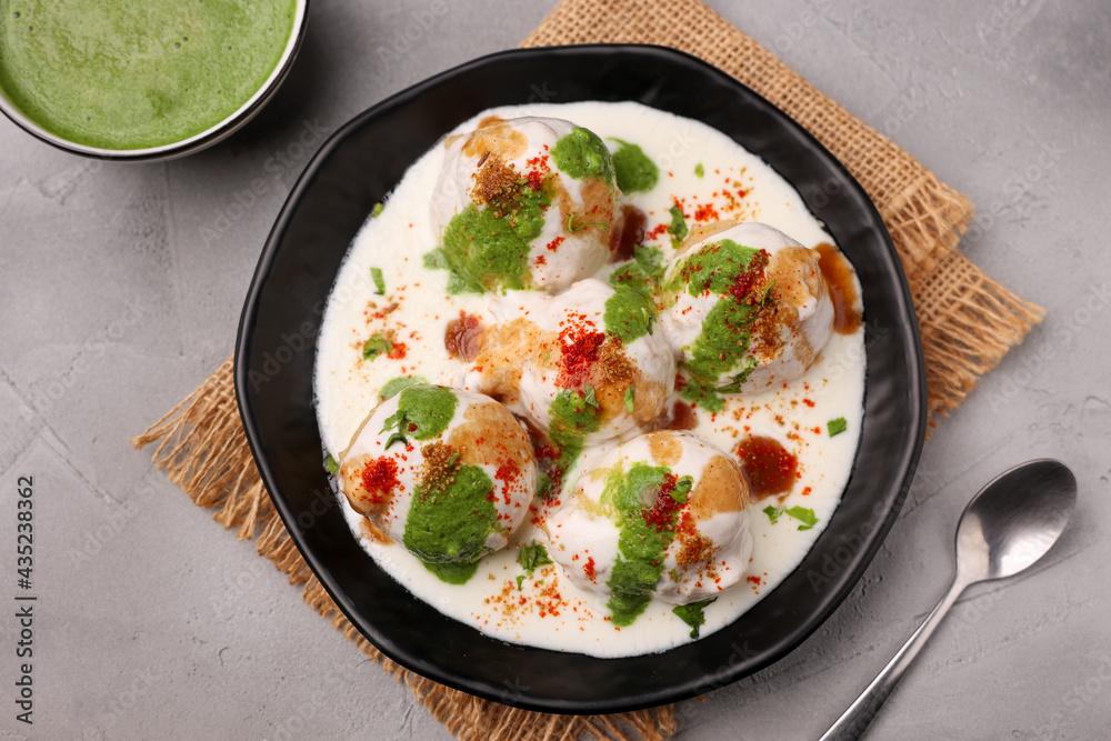 Indian street food Dahi vada Dahi Bhalla with green chutney, tamarind