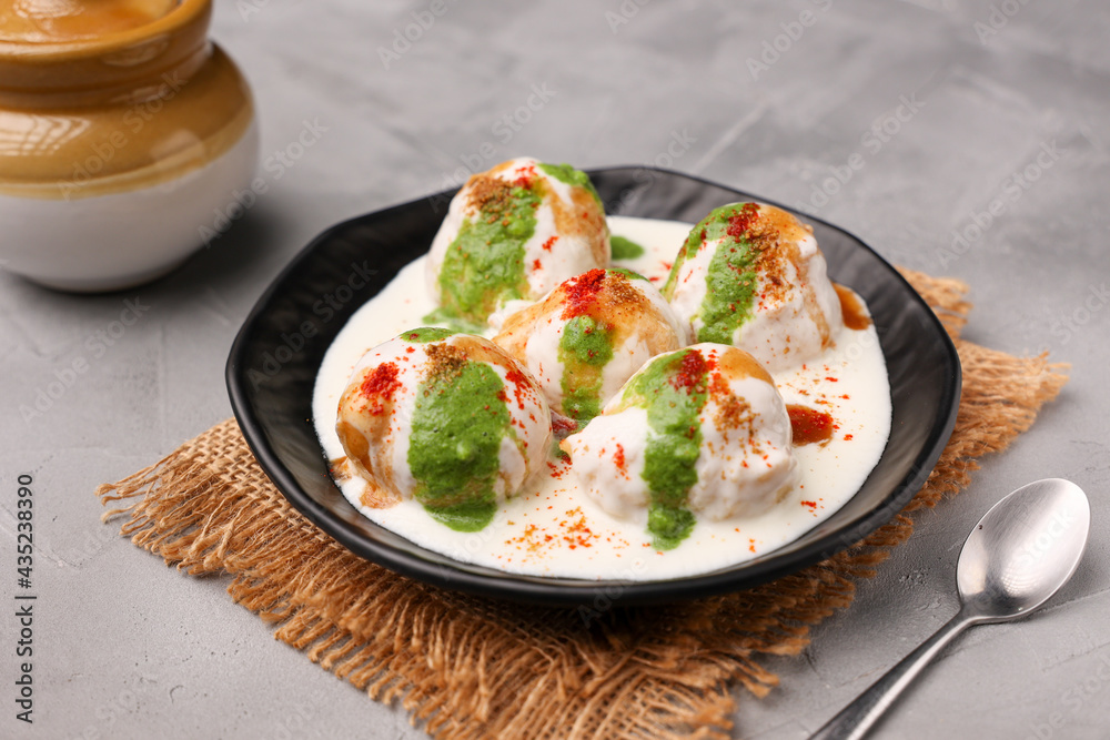 Indian street food Dahi vada Dahi Bhalla with green chutney, tamarind